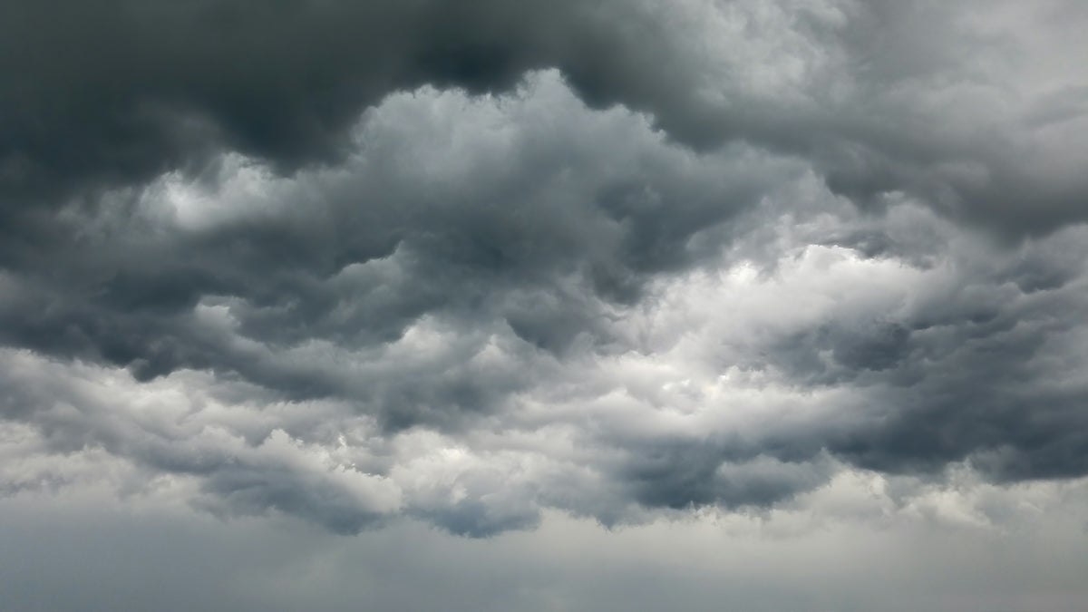 Dense dark grey storm clouds filling the sky