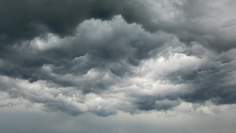 Dense dark grey storm clouds filling the sky